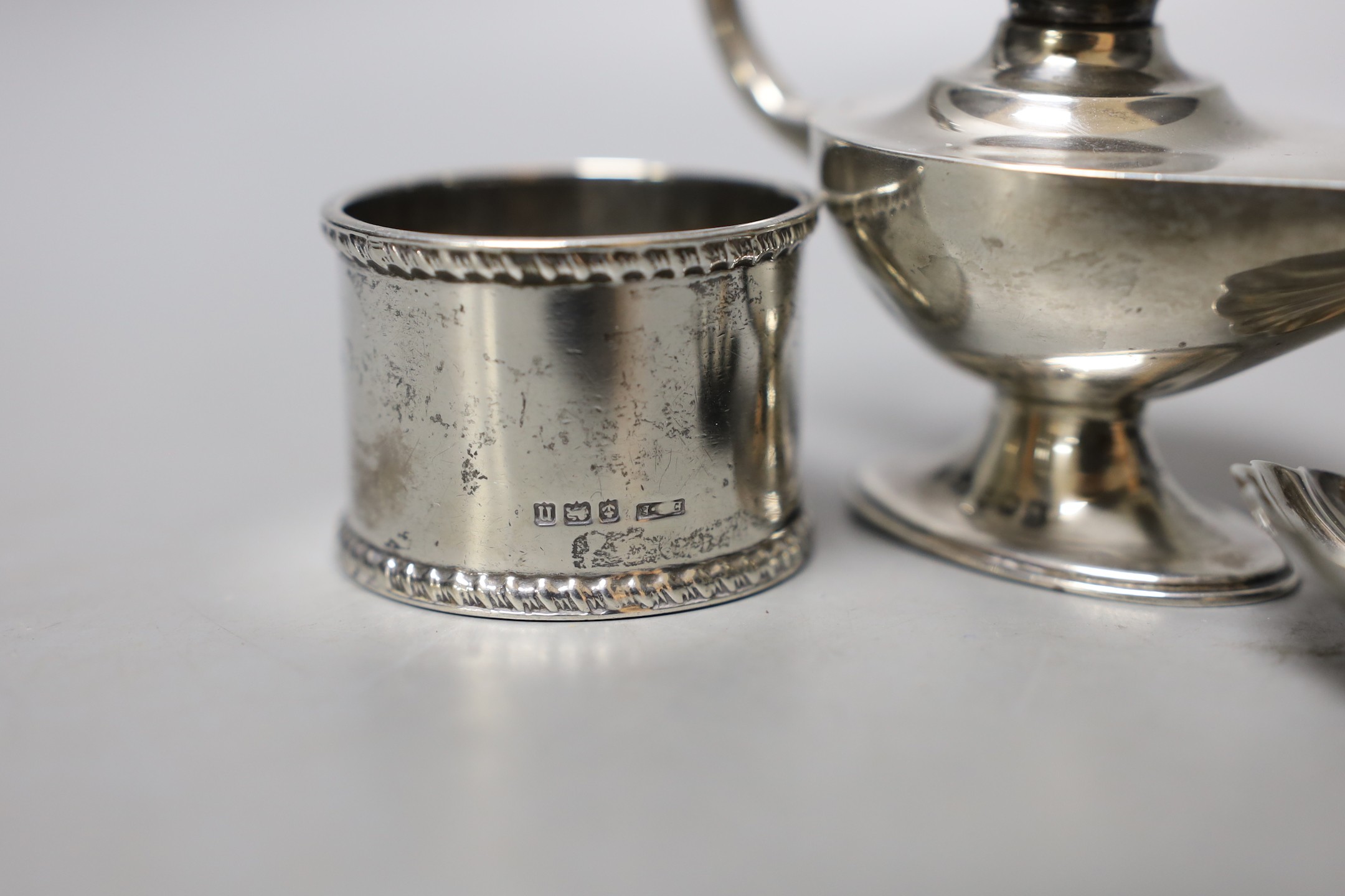 A George V silver 'Aladdin's Lamp' lighter (lacking cover), length 12cm, a silver napkin ring and a William IV silver caddy spoon, William Bateman, London, 1835.